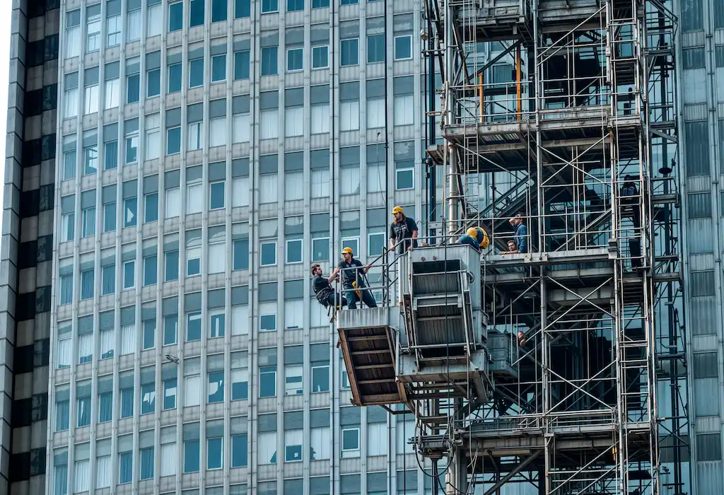 Construction workers operating on high-rise scaffolding installed by San Diego Elite Scaffolding