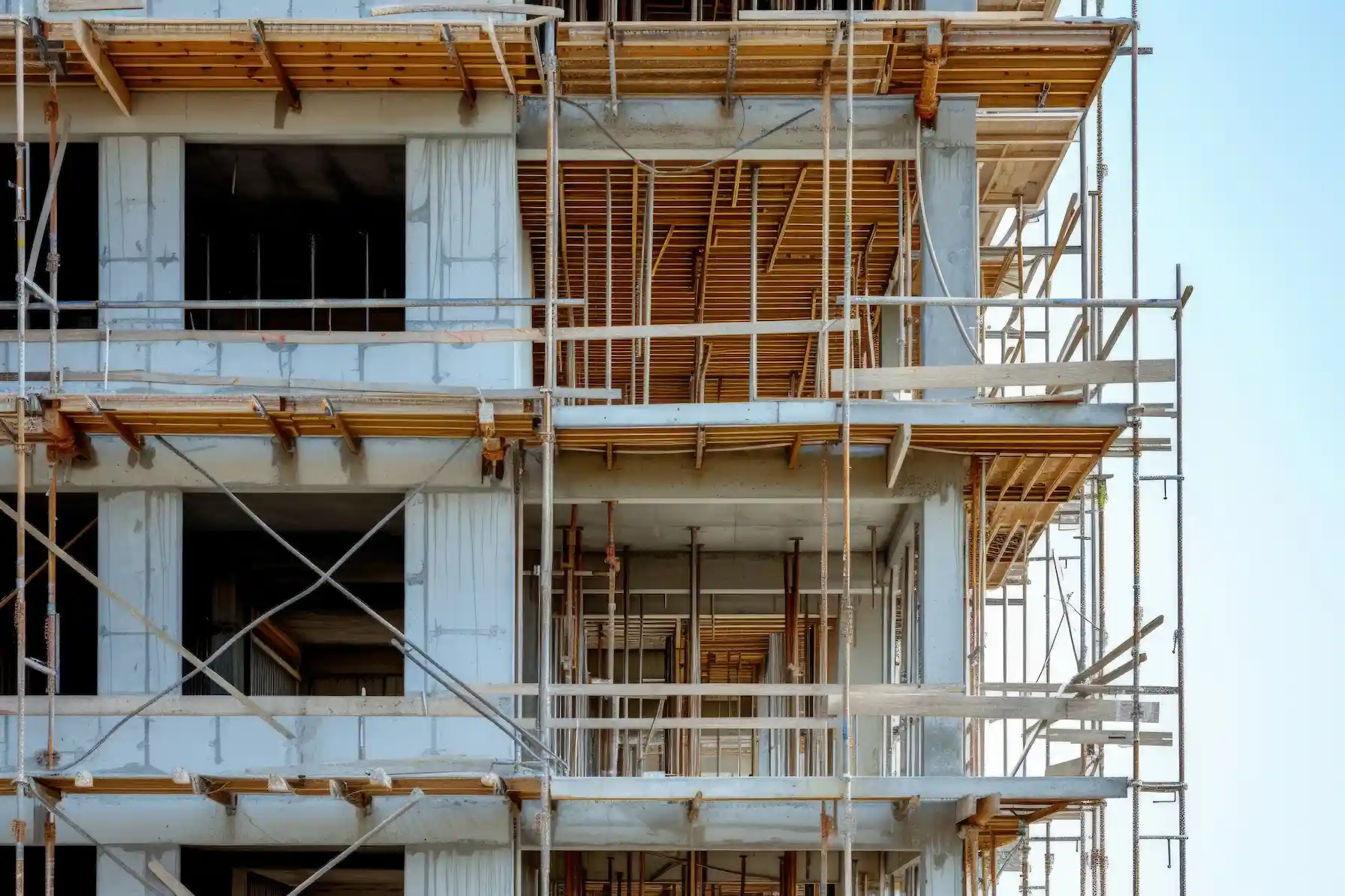 Wide view of modern construction site with reinforced scaffolding by San Diego Elite Scaffolding